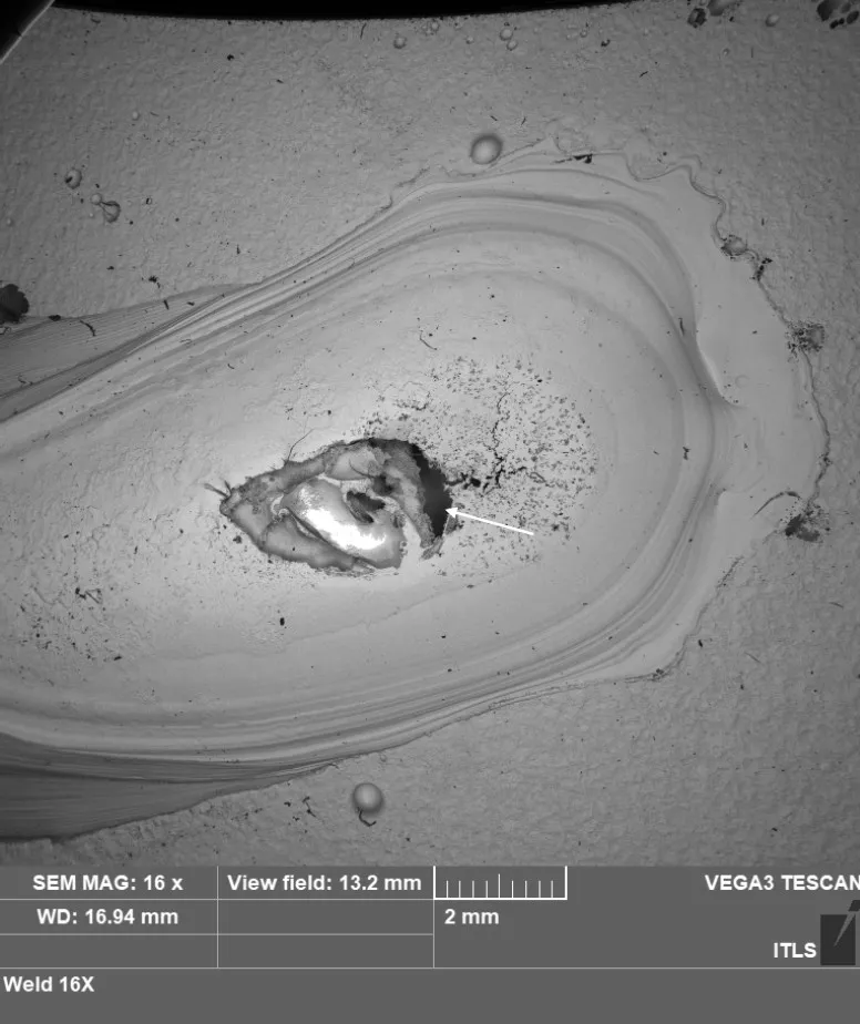 SEM micrograph at 16x magnification of the large crater silica island site on the weld bead