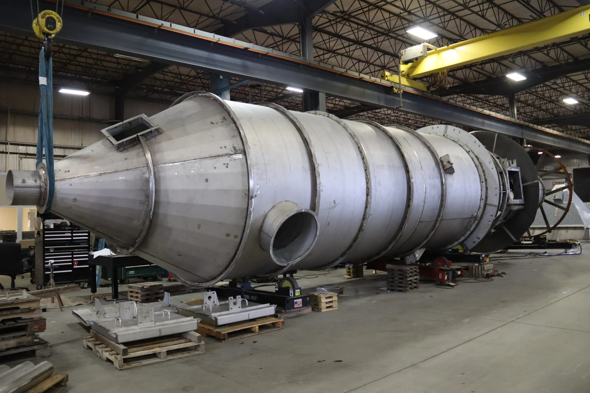 Hastelloy C-276 evaporative cooler with conical inlet section staged under an overhead crane at Northern Manufacturing