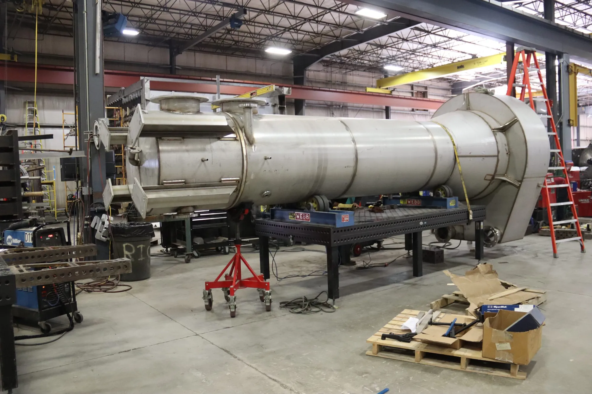 Large cylindrical stainless steel scrubber vessel with conical reducer during fabrication at Northern Manufacturing