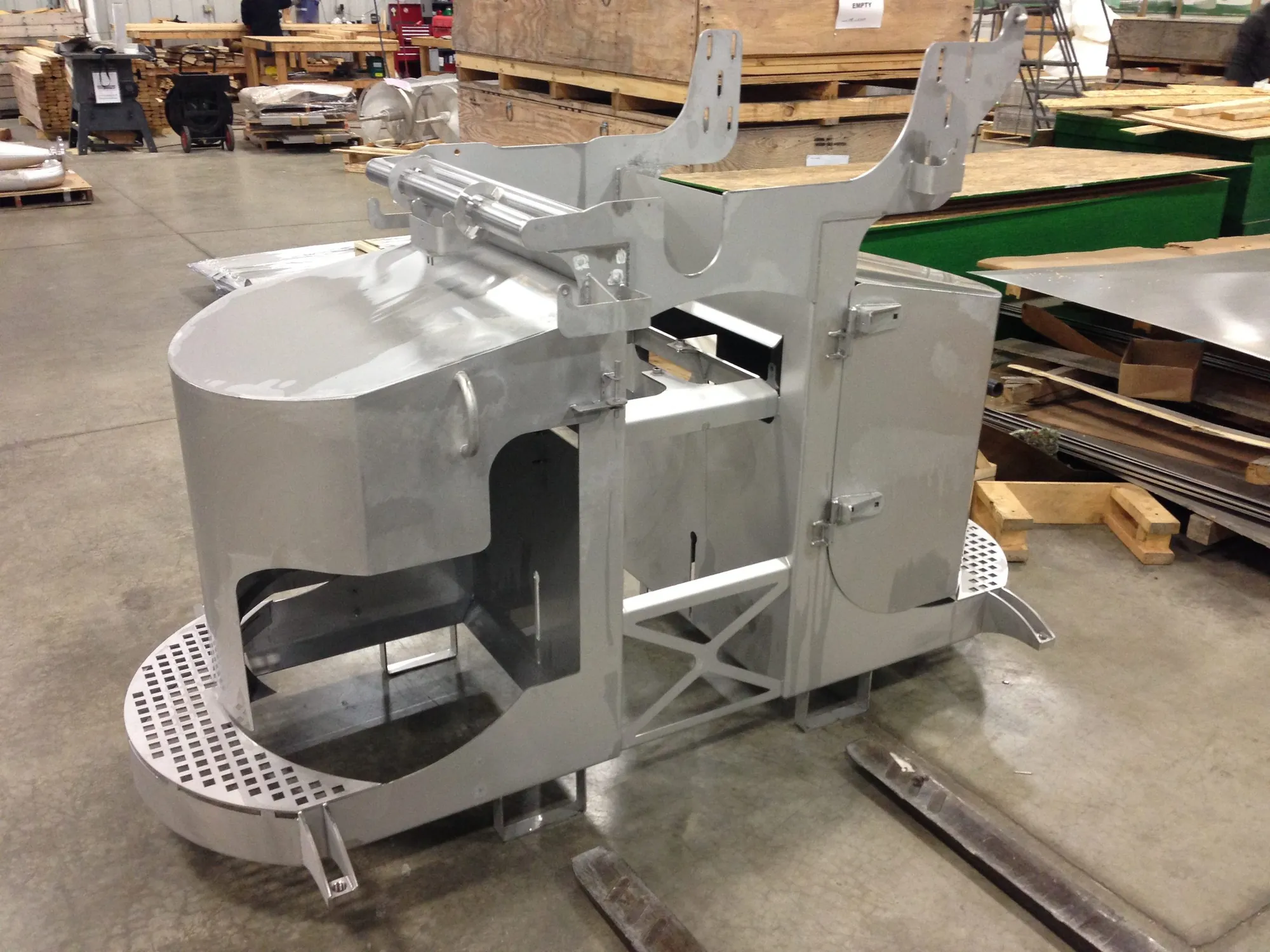 Skid-mounted stainless steel process frame with a perforated grate deck in the Northern Manufacturing shop