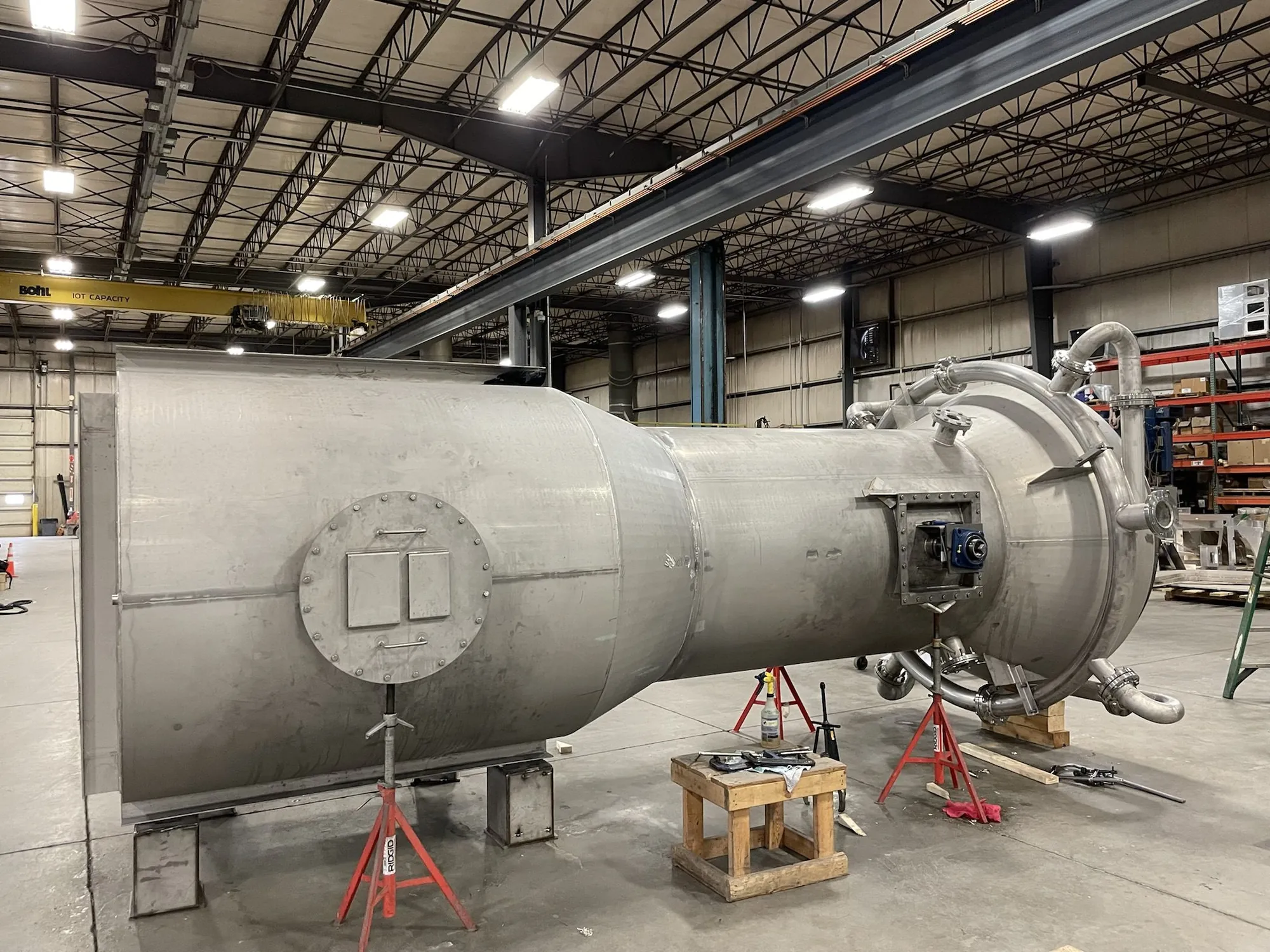 Horizontal stainless steel scrubber vessel with conical transition and nozzle piping during fabrication