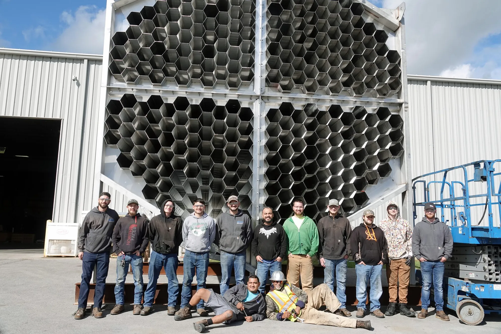 Northern crew in front of a WESP collector tube bundle in the yard