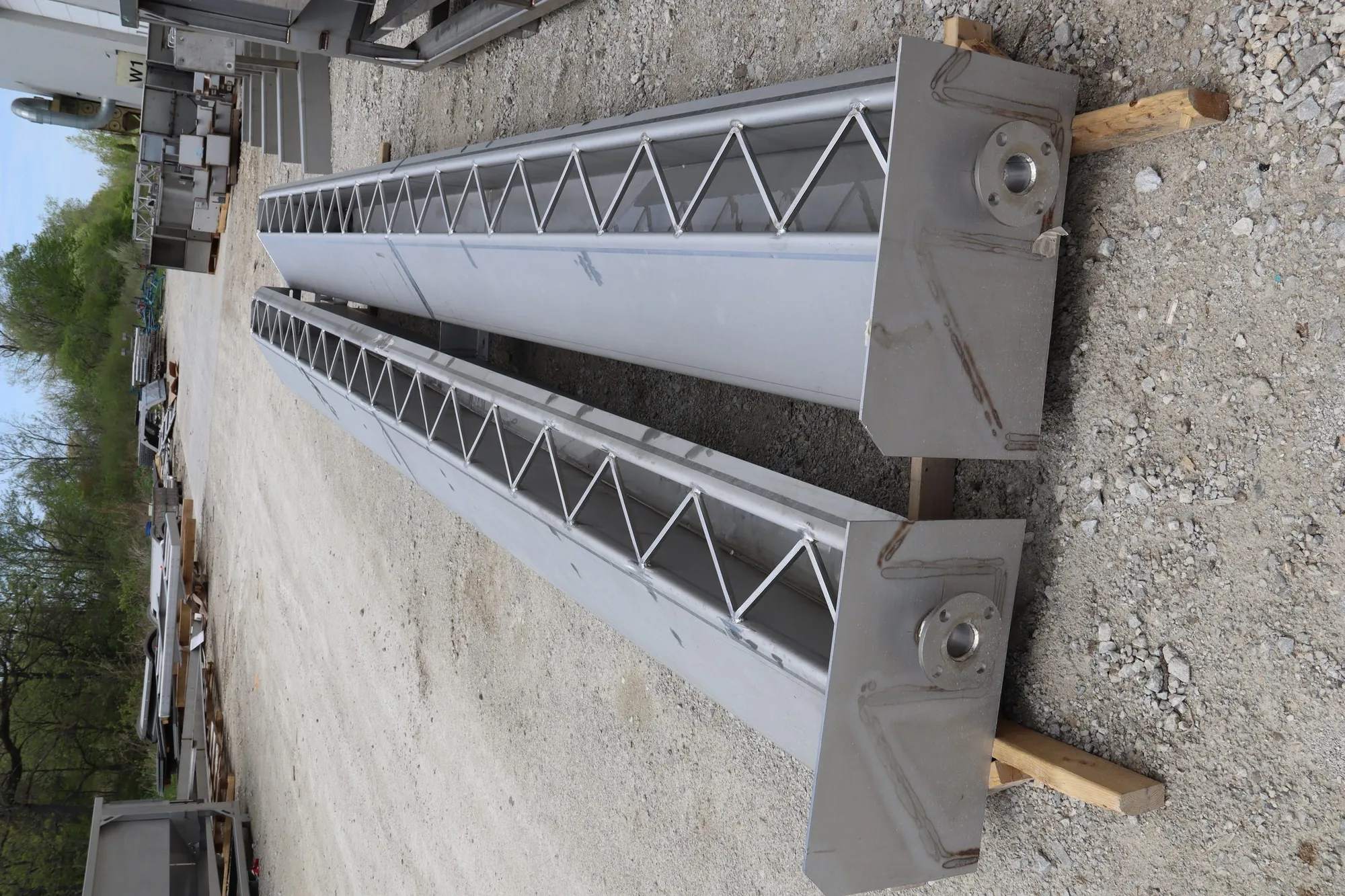 Stainless steel weir trough sections with v-notch pattern staged for shipment