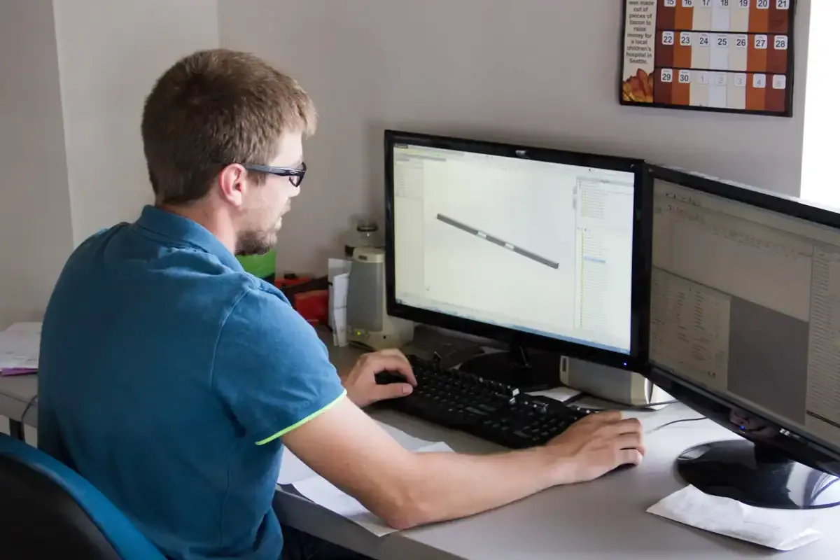 Northern Manufacturing engineer reviewing a customer 3D CAD model across dual monitors during production planning