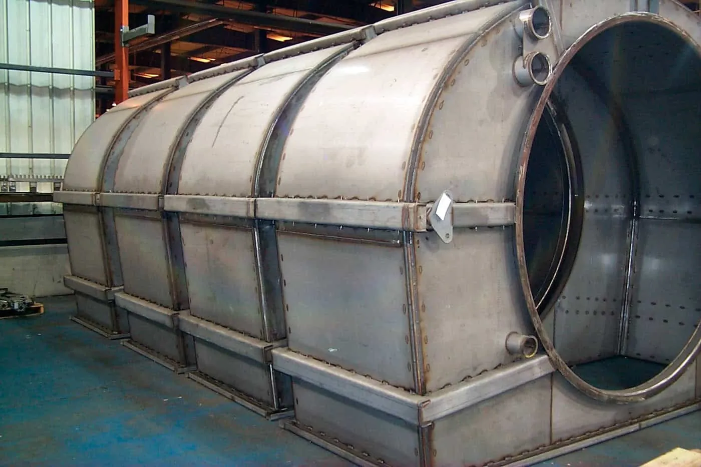 Heavy stainless steel cylindrical duct section with stiffening bands and a flanged access opening