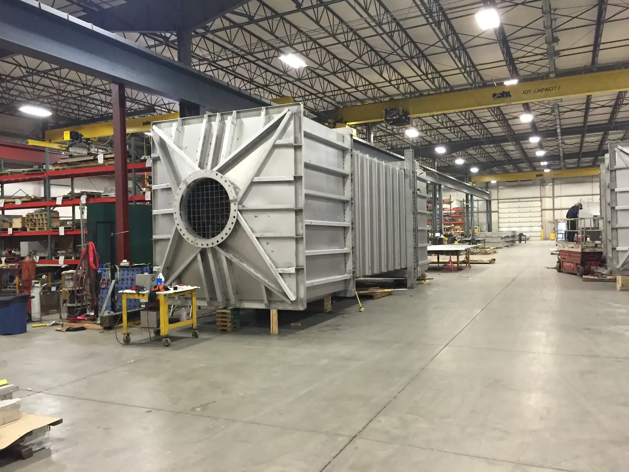 Large stainless steel fabrication with a round opening inside the Northern Manufacturing facility